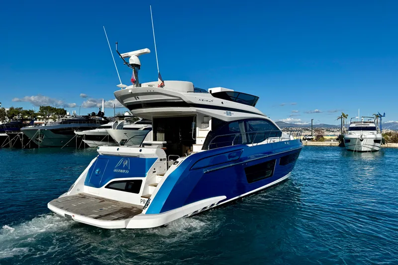  Yacht Photos Pics 2024 Azimut Fly 53 yacht cruising in a sunny marina, showcasing sleek design and luxury.
