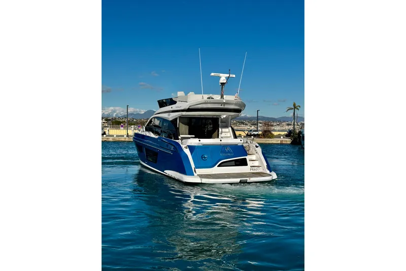  Yacht Photos Pics 2024 Azimut Fly 53 yacht cruising in a sunny marina setting.