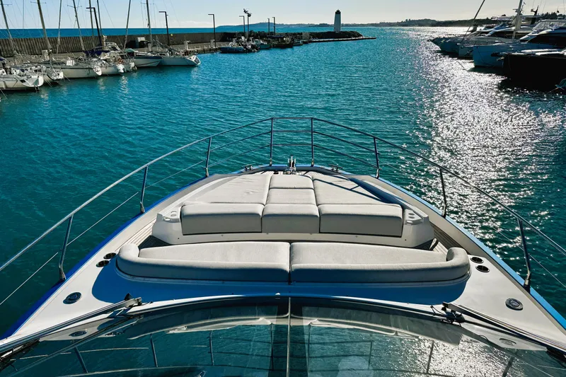  Yacht Photos Pics 2024 Azimut Fly 53 yacht in a serene marina, showcasing luxurious deck seating.