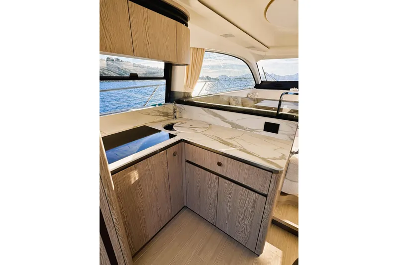  Yacht Photos Pics Luxurious kitchen interior of 2024 Azimut Fly 53 yacht with marble countertops and ocean view.