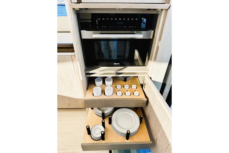  Yacht Photos Pics Modern kitchen in 2024 Azimut Fly 53 yacht with Miele appliances and organized dish storage.