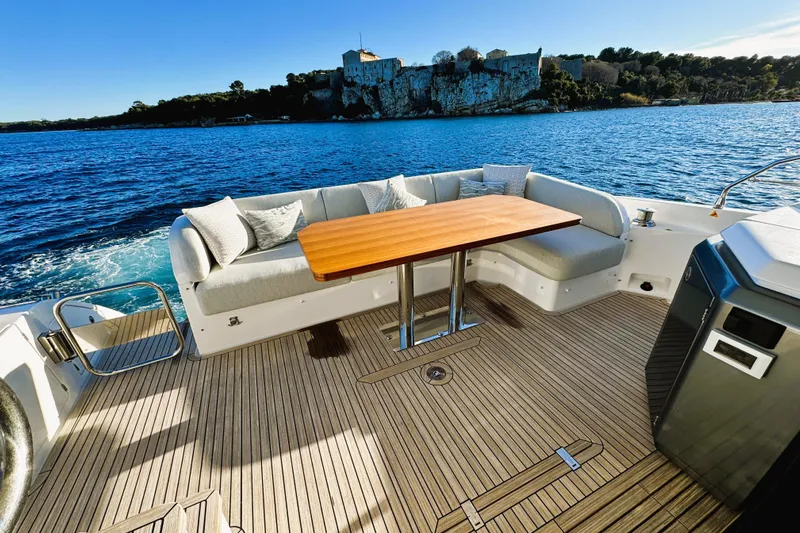  Yacht Photos Pics Luxurious Azimut Fly 53 yacht deck with seating, table, and scenic ocean view, 2024 model.