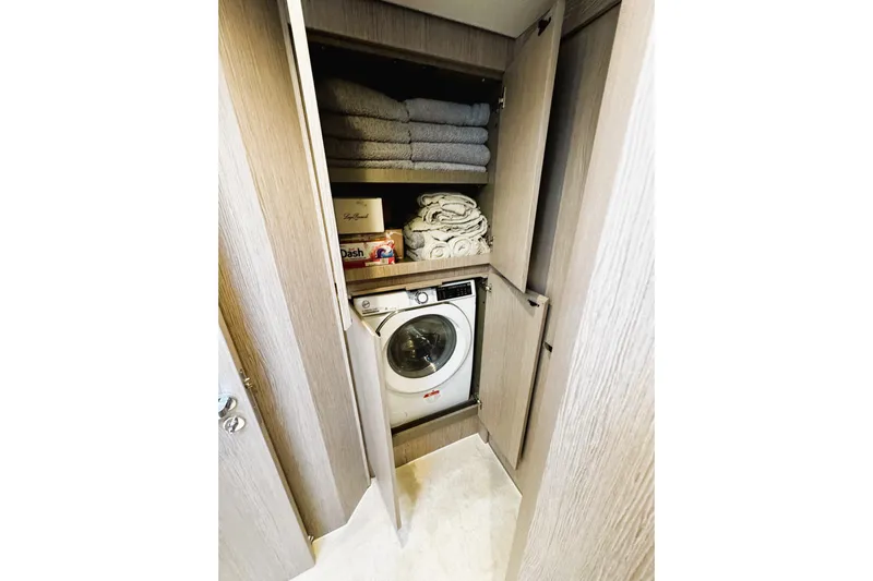  Yacht Photos Pics Laundry area with washer, towels, and supplies in 2024 Azimut Fly 53 yacht.