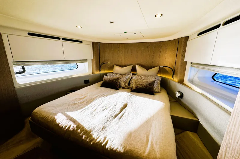  Yacht Photos Pics Luxurious bedroom interior of 2024 Azimut Fly 53 yacht with elegant bedding and natural light.