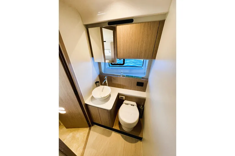 Yacht Photos Pics Luxurious bathroom in 2024 Azimut Fly 53 yacht with modern fixtures and wood accents.