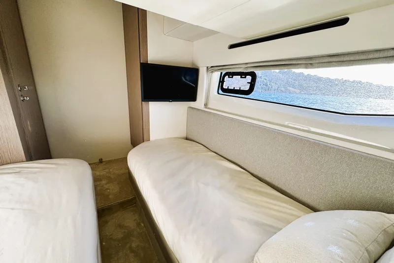  Yacht Photos Pics 2024 Azimut Fly 53 yacht interior with twin beds and sea view window.