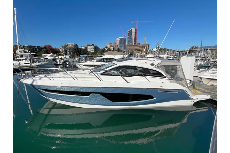  Yacht Photos Pics 2024 Sessa Marine C38 yacht docked in a marina, with cityscape background.