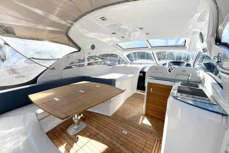  Yacht Photos Pics 2024 Sessa Marine C38 yacht interior with sleek design, wooden table, and modern amenities.
