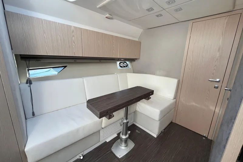  Yacht Photos Pics 2024 Sessa Marine C38 yacht interior with white seating and wooden table.