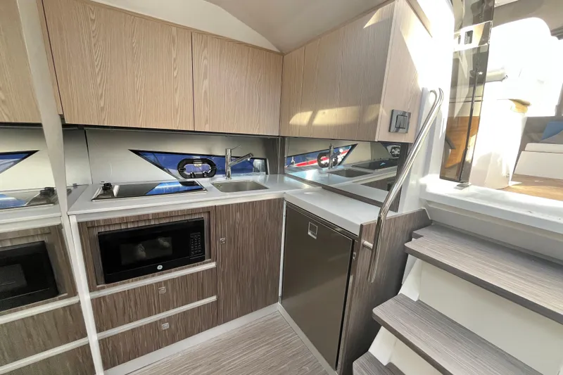  Yacht Photos Pics Modern kitchen interior of 2024 Sessa Marine C38 yacht with sleek cabinetry and appliances.