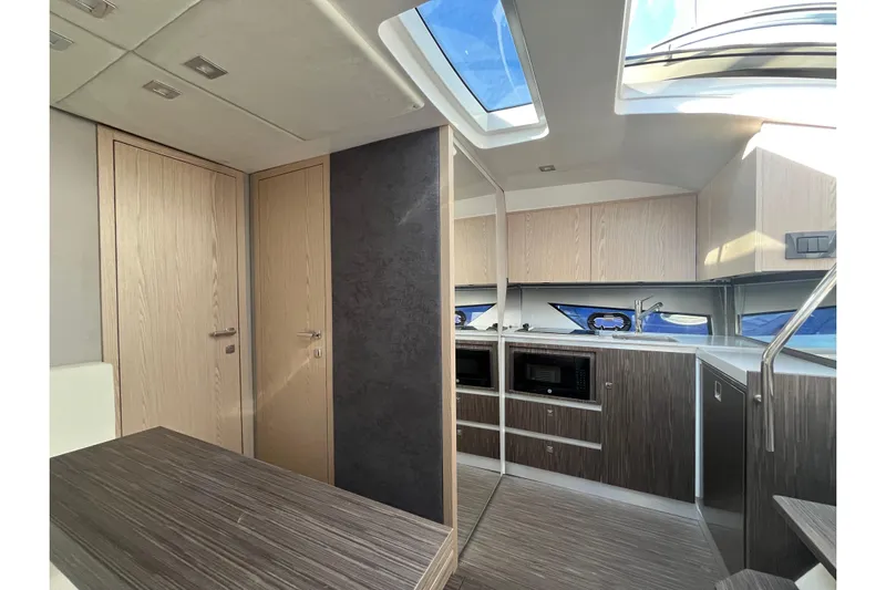  Yacht Photos Pics Luxurious interior of 2024 Sessa Marine C38 yacht with modern kitchen and skylight.