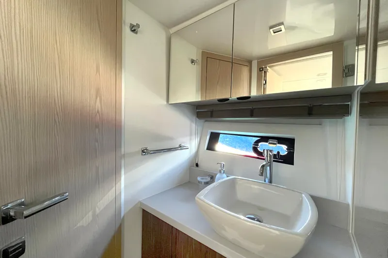  Yacht Photos Pics Modern bathroom interior of 2024 Sessa Marine C38 yacht with sleek sink and mirror.