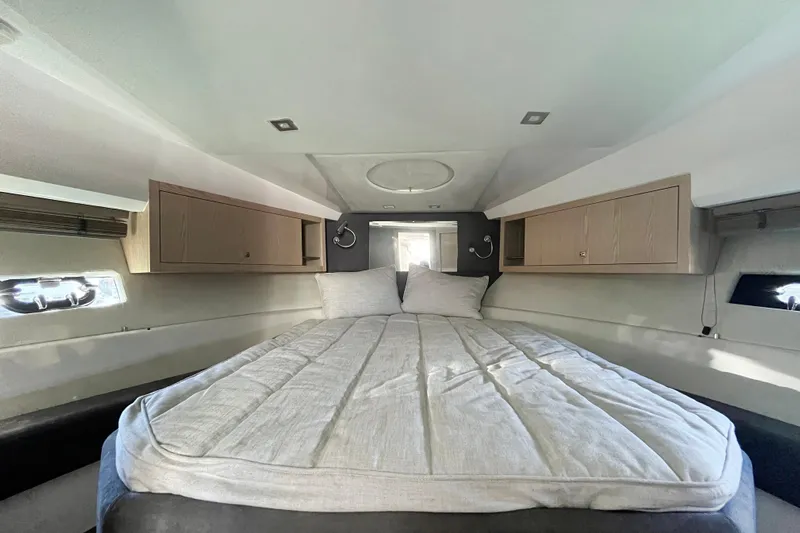  Yacht Photos Pics 2024 Sessa Marine C38 cabin interior with bed and storage cabinets.