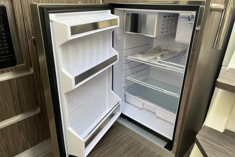 Yacht Photos Pics Open refrigerator inside 2024 Sessa Marine C38 yacht, featuring spacious shelves and modern design.