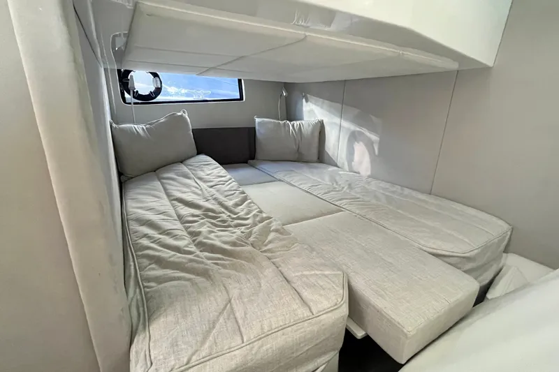  Yacht Photos Pics 2024 Sessa Marine C38 cabin interior with cozy bedding and window view.