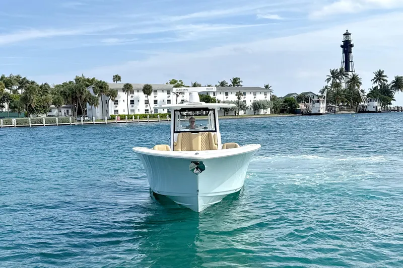 Scungilli Yacht Photos Pics 2023 Sportsman Open 352 Center Console boat on blue water near a lighthouse.