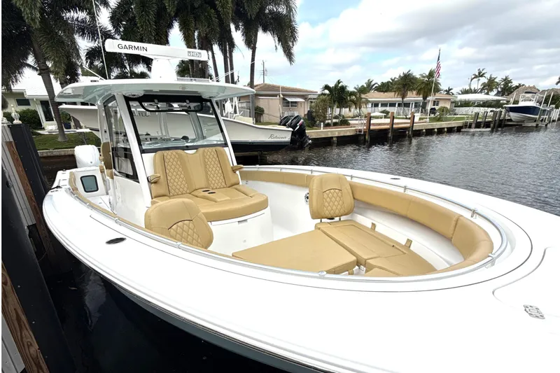Scungilli Yacht Photos Pics 2023 Sportsman Open 352 Center Console boat docked by waterfront homes.