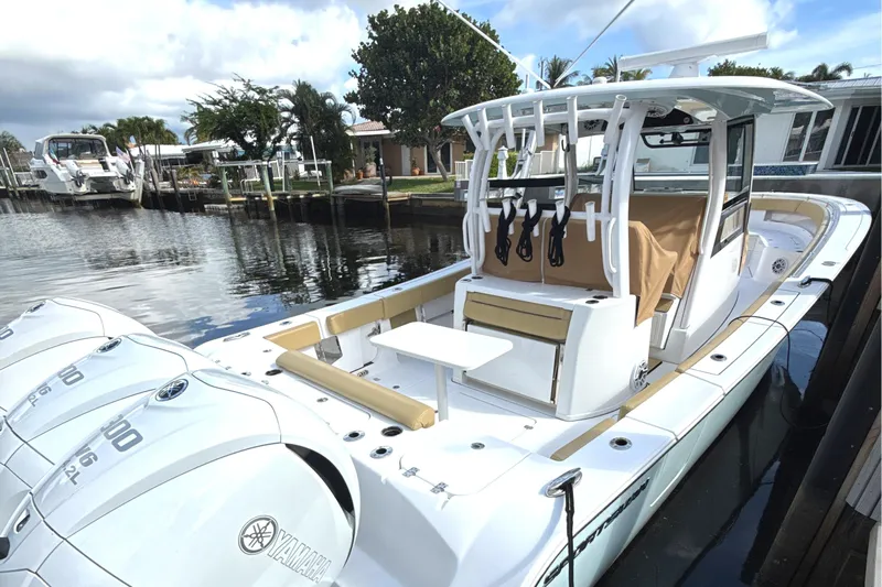 Scungilli Yacht Photos Pics 2023 Sportsman Open 352 Center Console boat docked, featuring triple Yamaha engines.