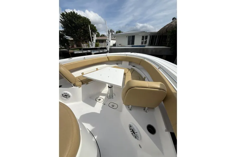 Scungilli Yacht Photos Pics 2023 Sportsman Open 352 Center Console boat with tan seating and white table.