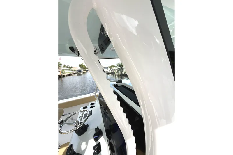 Scungilli Yacht Photos Pics 2023 Sportsman Open 352 Center Console boat interior with steering wheel and water view.