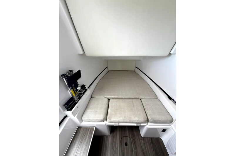 Scungilli Yacht Photos Pics 2023 Sportsman Open 352 Center Console cabin interior with cushioned seating and storage.