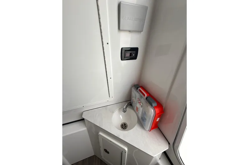 Scungilli Yacht Photos Pics 2023 Sportsman Open 352 Center Console interior with sink and first aid kit.