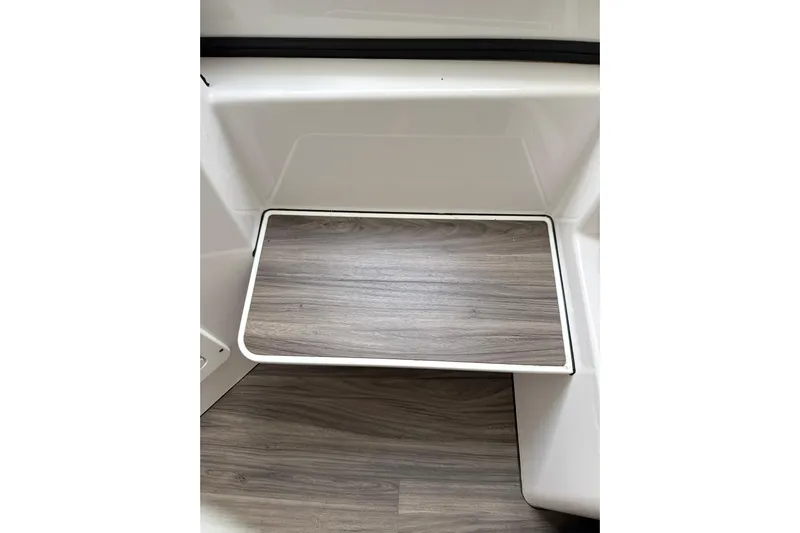 Scungilli Yacht Photos Pics 2023 Sportsman Open 352 Center Console interior with wood-textured step detail.