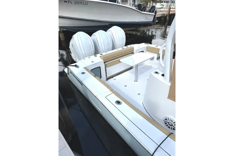 Scungilli Yacht Photos Pics 2023 Sportsman Open 352 Center Console boat docked, featuring triple engines and spacious seating.