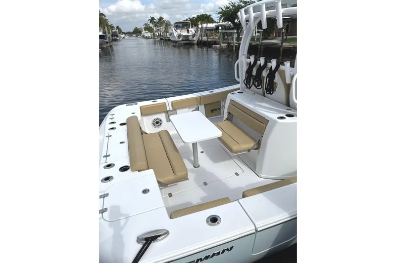Scungilli Yacht Photos Pics 2023 Sportsman Open 352 Center Console boat with seating and table on a calm waterway.