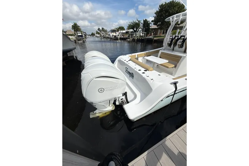 Scungilli Yacht Photos Pics 2023 Sportsman Open 352 Center Console boat with Yamaha engines docked by the water.