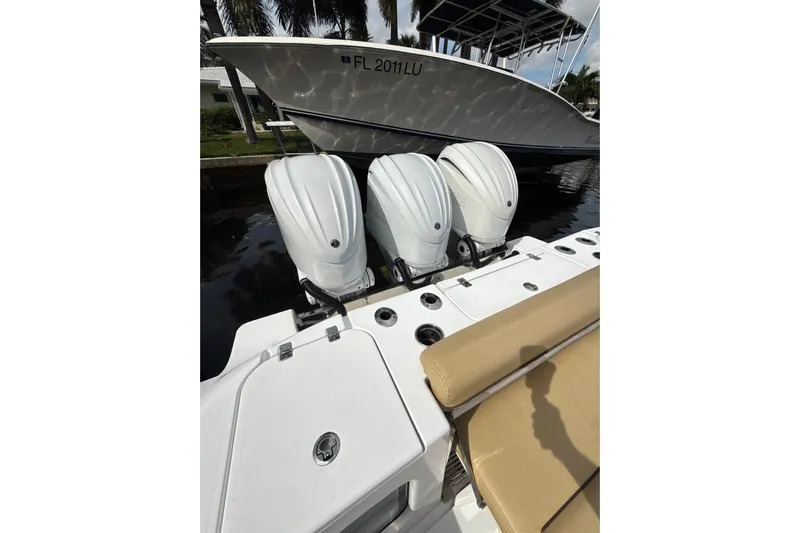Scungilli Yacht Photos Pics 2023 Sportsman Open 352 Center Console with triple outboard engines docked.