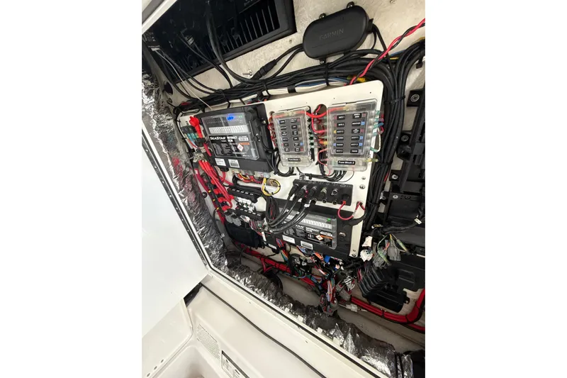 Scungilli Yacht Photos Pics Electrical panel of 2023 Sportsman Open 352 Center Console boat, showcasing wiring and components.