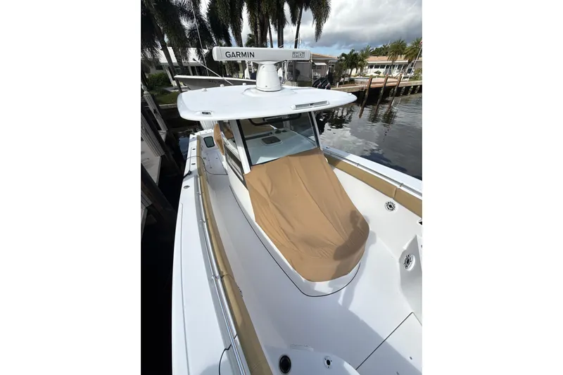 Scungilli Yacht Photos Pics 2023 Sportsman Open 352 Center Console boat docked by palm trees.