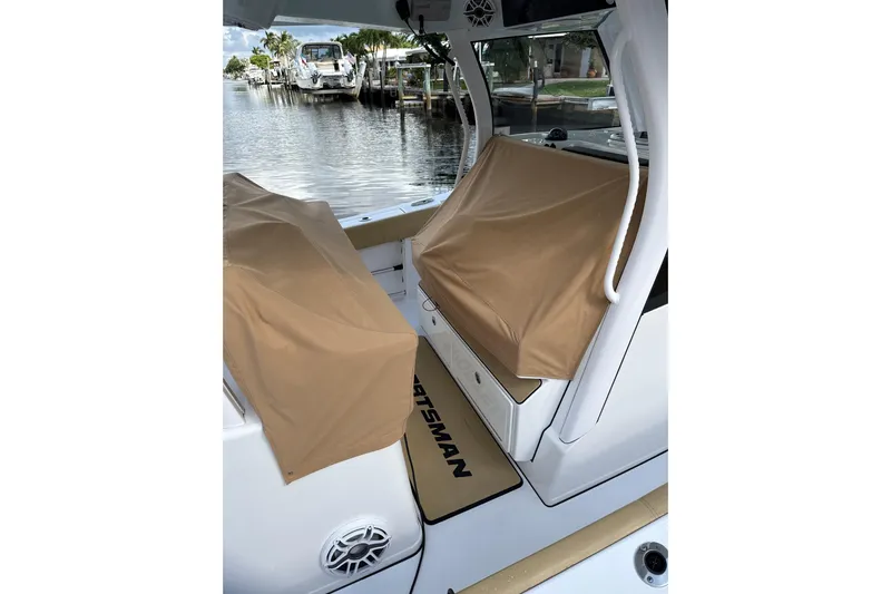 Scungilli Yacht Photos Pics 2023 Sportsman Open 352 Center Console boat with covered seating, docked by the water.