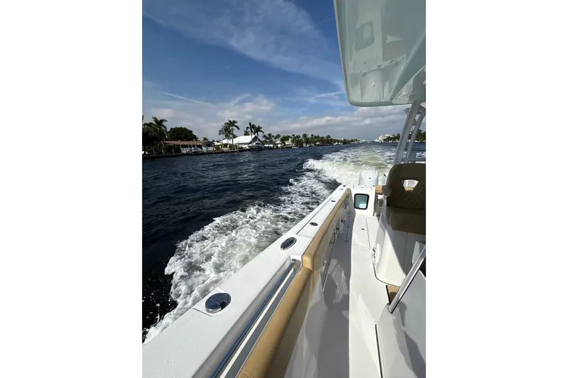 Scungilli Yacht Photos Pics 2023 Sportsman Open 352 Center Console cruising on a sunny day, leaving a wake.