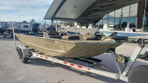 2017 Tracker 2072 boat on a trailer in a marina parking lot.