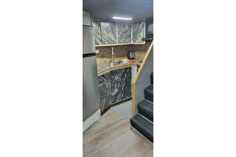 Alliance Yacht Photos Pics Modern kitchen interior in 2022 Custom Freestyle Marine 32 boat, featuring sleek cabinetry and appliances.