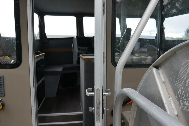 Alliance Yacht Photos Pics Interior view of 2022 Custom Freestyle Marine 32 boat, showcasing cabin and seating area.