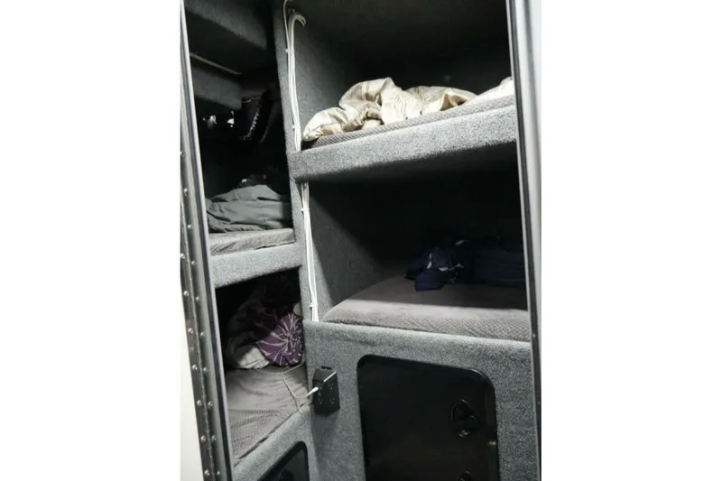 Alliance Yacht Photos Pics Interior of 2022 Custom Freestyle Marine 32 with compact, carpeted sleeping bunks.