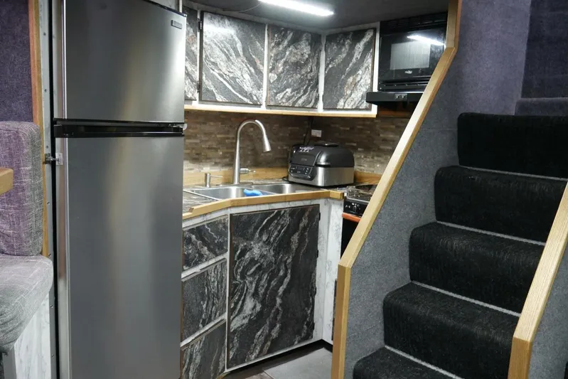 Alliance Yacht Photos Pics Modern kitchen interior in 2022 Custom Freestyle Marine 32, featuring sleek appliances and stylish cabinetry.