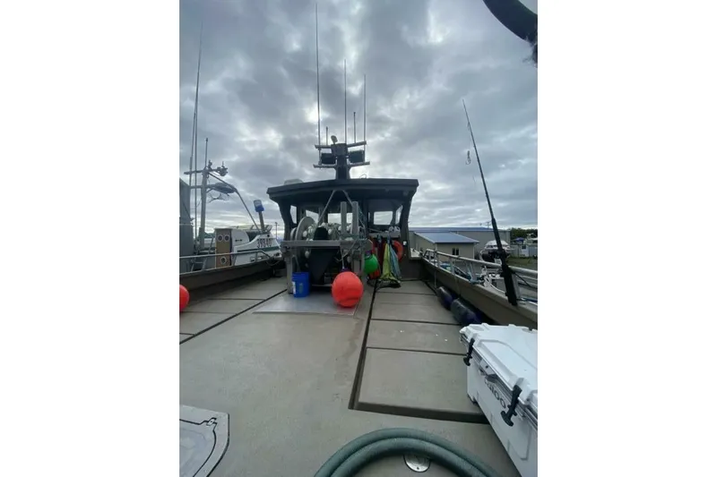 Alliance Yacht Photos Pics Custom Freestyle Marine 32 boat, 2022 model, docked under cloudy skies with marine equipment.