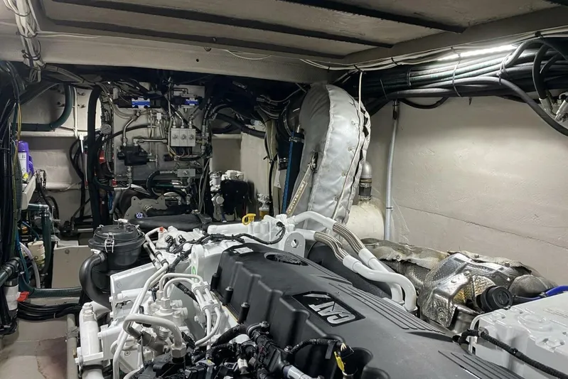 Alliance Yacht Photos Pics Engine room of a 2022 Custom Freestyle Marine 32 boat, showcasing complex machinery and wiring.