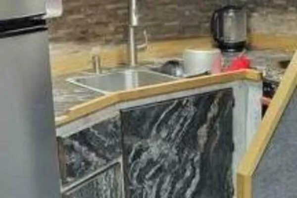 Alliance Yacht Photos Pics Modern kitchen area in a 2022 Custom Freestyle Marine 32 boat, featuring sleek countertops and appliances.