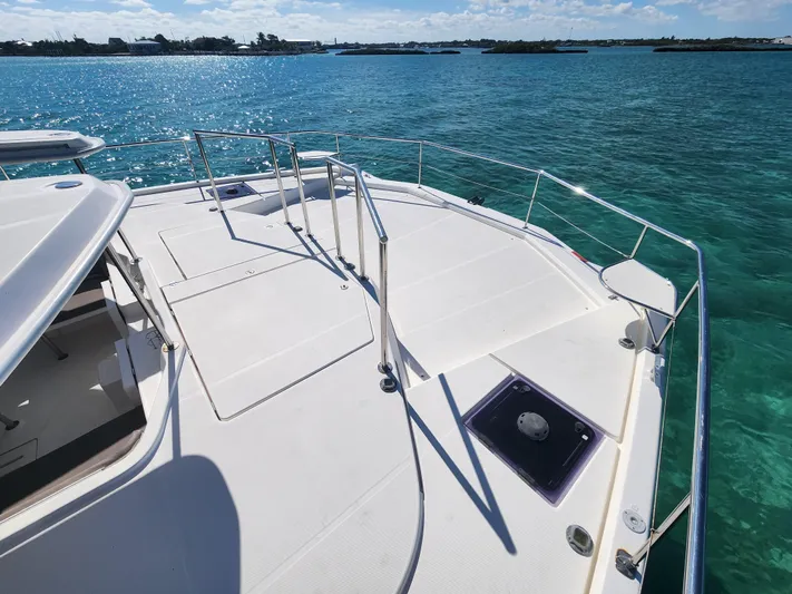 Salty Mitches Yacht Photos Pics 2016 Leopard 51 Powercat yacht deck overlooking clear turquoise waters.