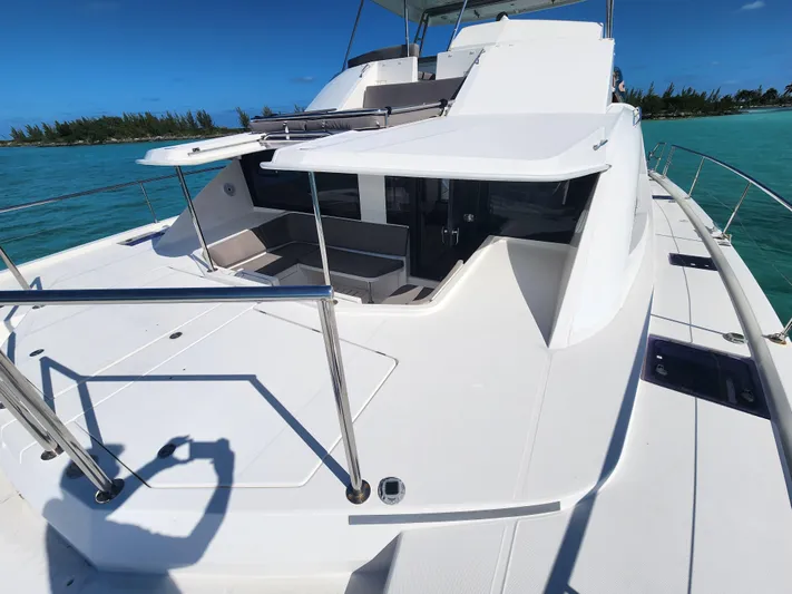 Salty Mitches Yacht Photos Pics 2016 Leopard 51 Powercat yacht on turquoise water, featuring spacious deck and seating area.