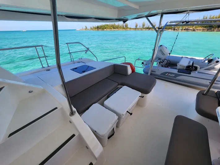 Salty Mitches Yacht Photos Pics 2016 Leopard 51 Powercat interior with seating, overlooking turquoise ocean and distant shoreline.
