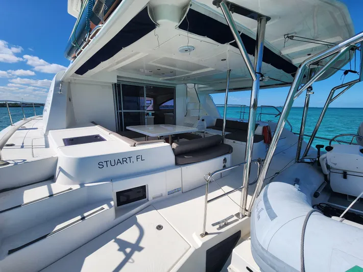 Salty Mitches Yacht Photos Pics 2016 Leopard 51 Powercat yacht with spacious deck, docked in Stuart, FL, under clear skies.