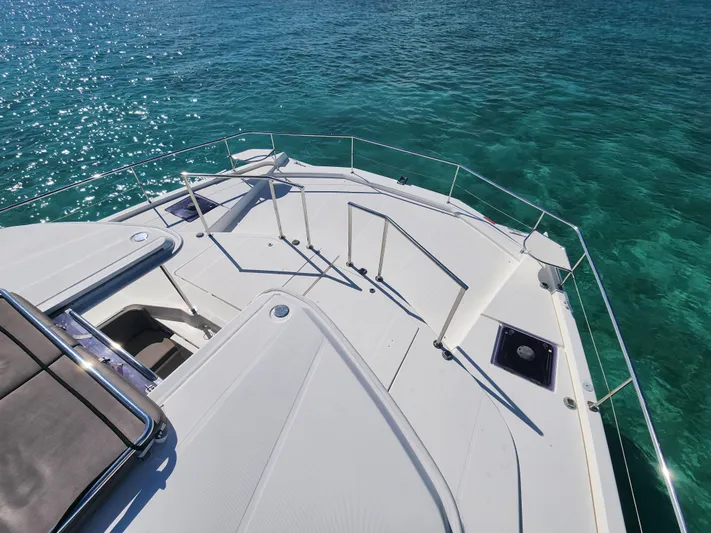 Salty Mitches Yacht Photos Pics 2016 Leopard 51 Powercat deck overlooking clear turquoise water.