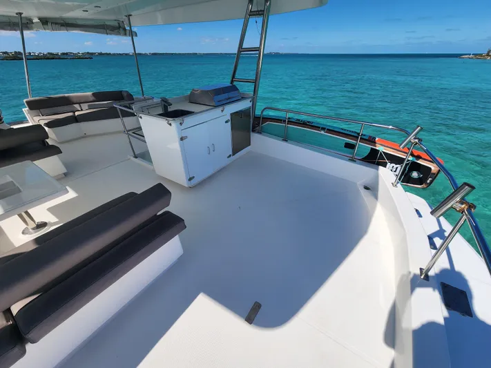 Salty Mitches Yacht Photos Pics 2016 Leopard 51 Powercat deck with seating, grill, and ocean view.