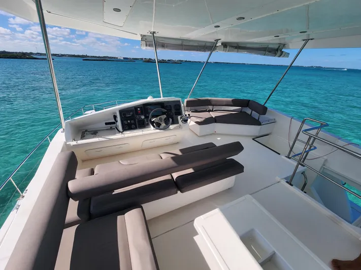 Salty Mitches Yacht Photos Pics Flybridge of 2016 Leopard 51 Powercat with seating, helm, and ocean view.